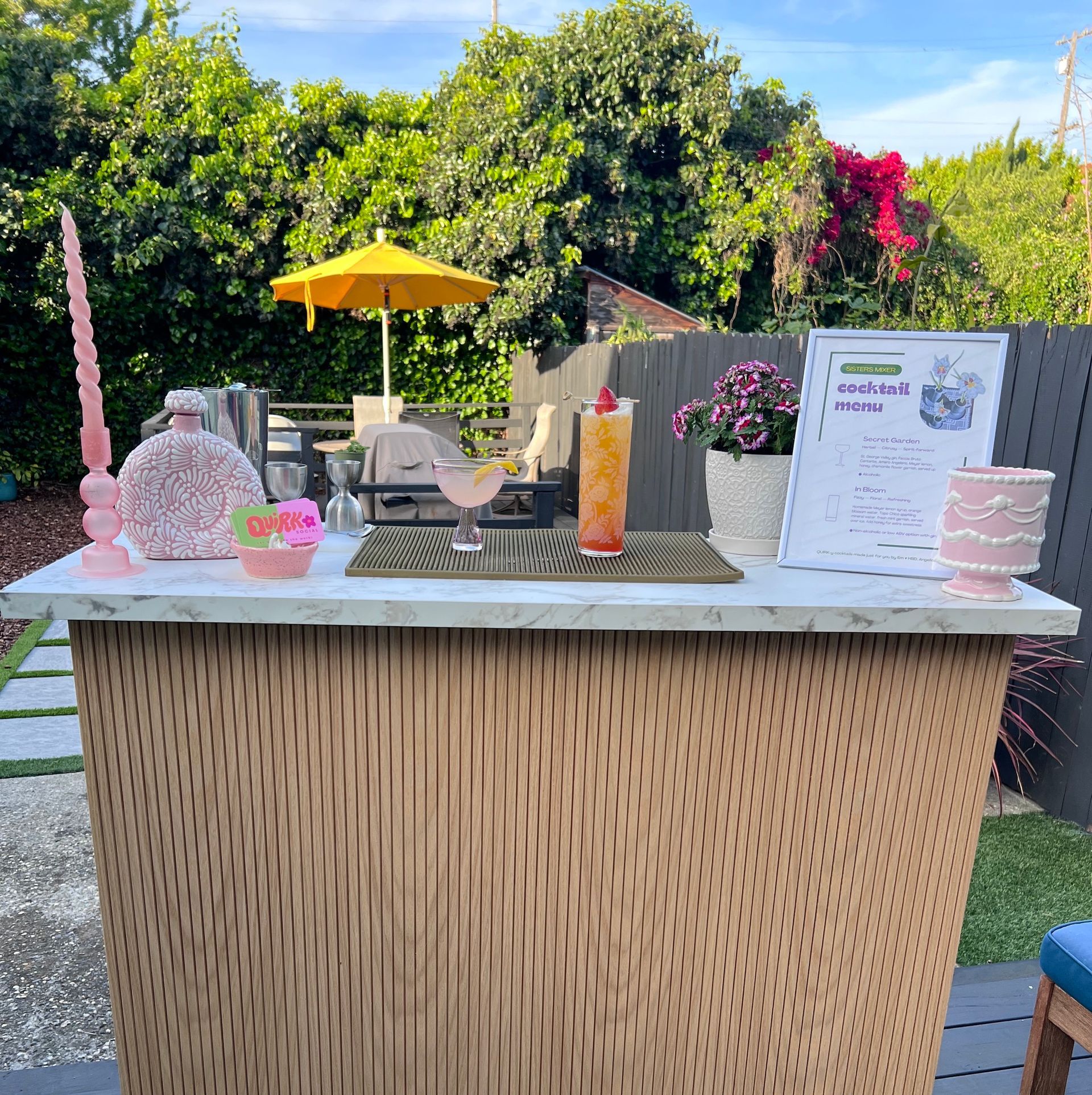 Craft cocktail bartender in Oakland CA for events with a sour cocktail served up and a fruity long drink served in a highball glass over ice on Quirk's portable bar