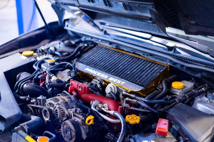 A close up of a car engine with the hood open.