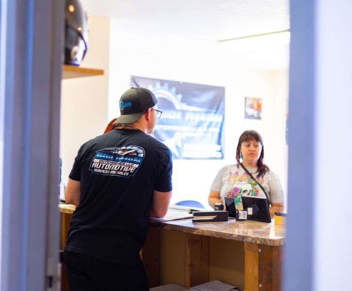A man in a black shirt with the word motorcycle on the back