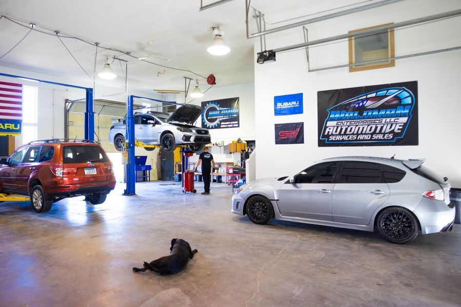 A man is working on a car in a garage.