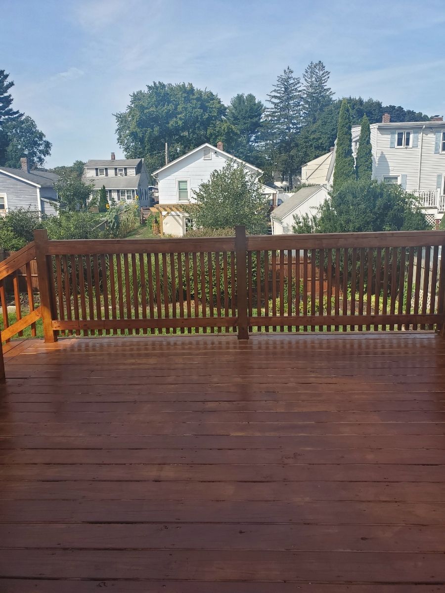 An empty deck with a wooden railing overlooking a residential area – Malden, MA – EG Remodeling LLC