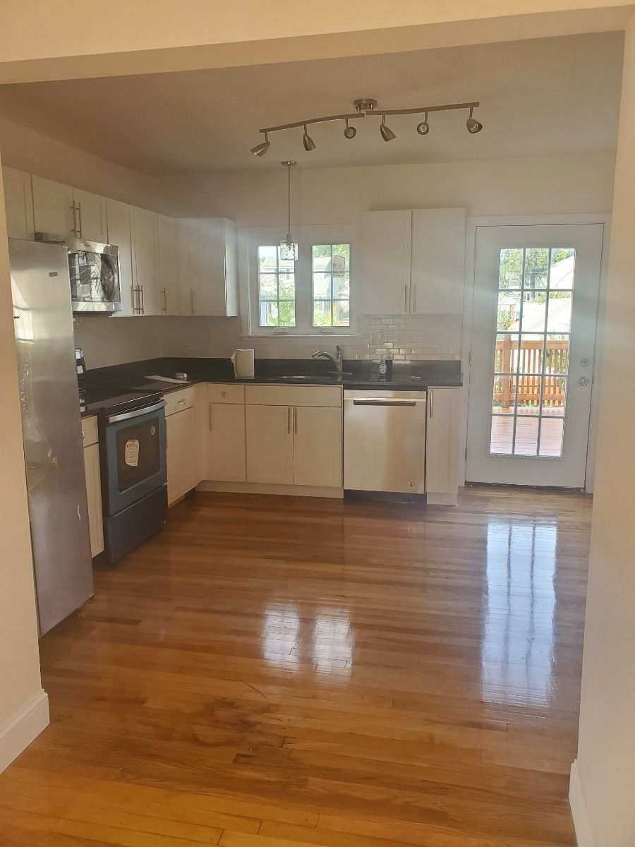 A kitchen with white cabinets and Stainless steel appliances  – Malden, MA – EG Remodeling LLC