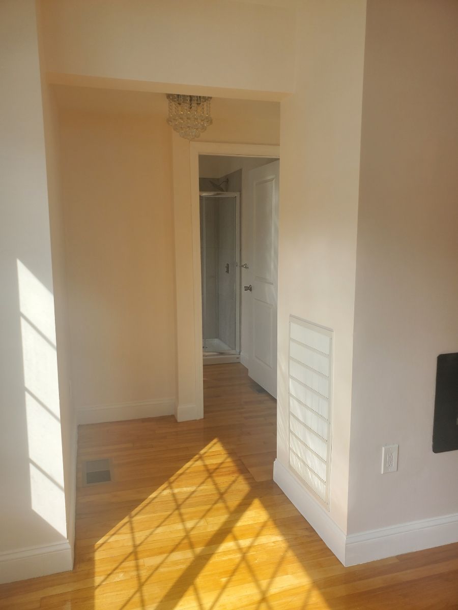 Shot of an empty room leading to bathroom – Malden, MA – EG Remodeling LLC