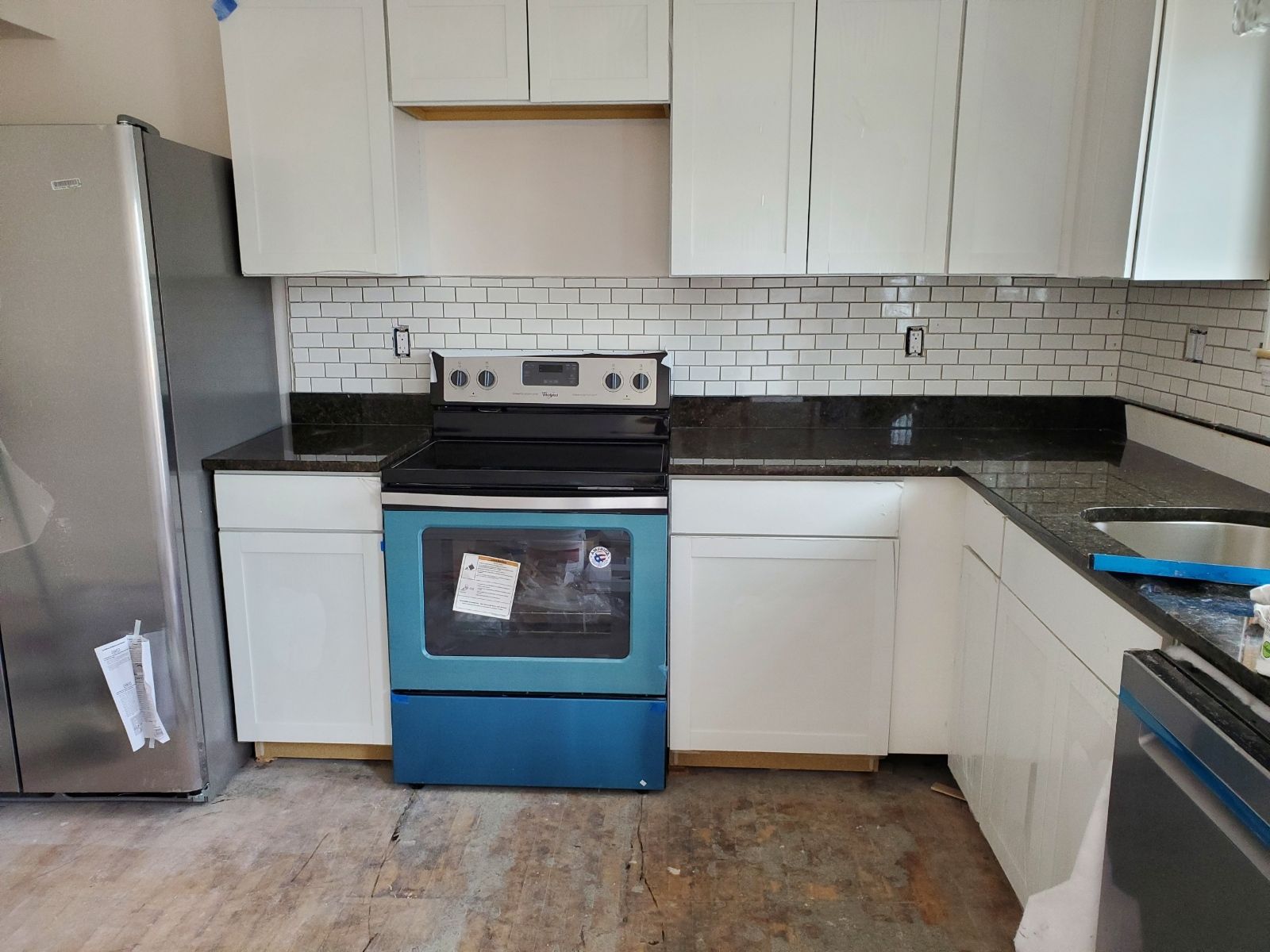 A kitchen with white cabinets and a blue stove  – Malden, MA – EG Remodeling LLC