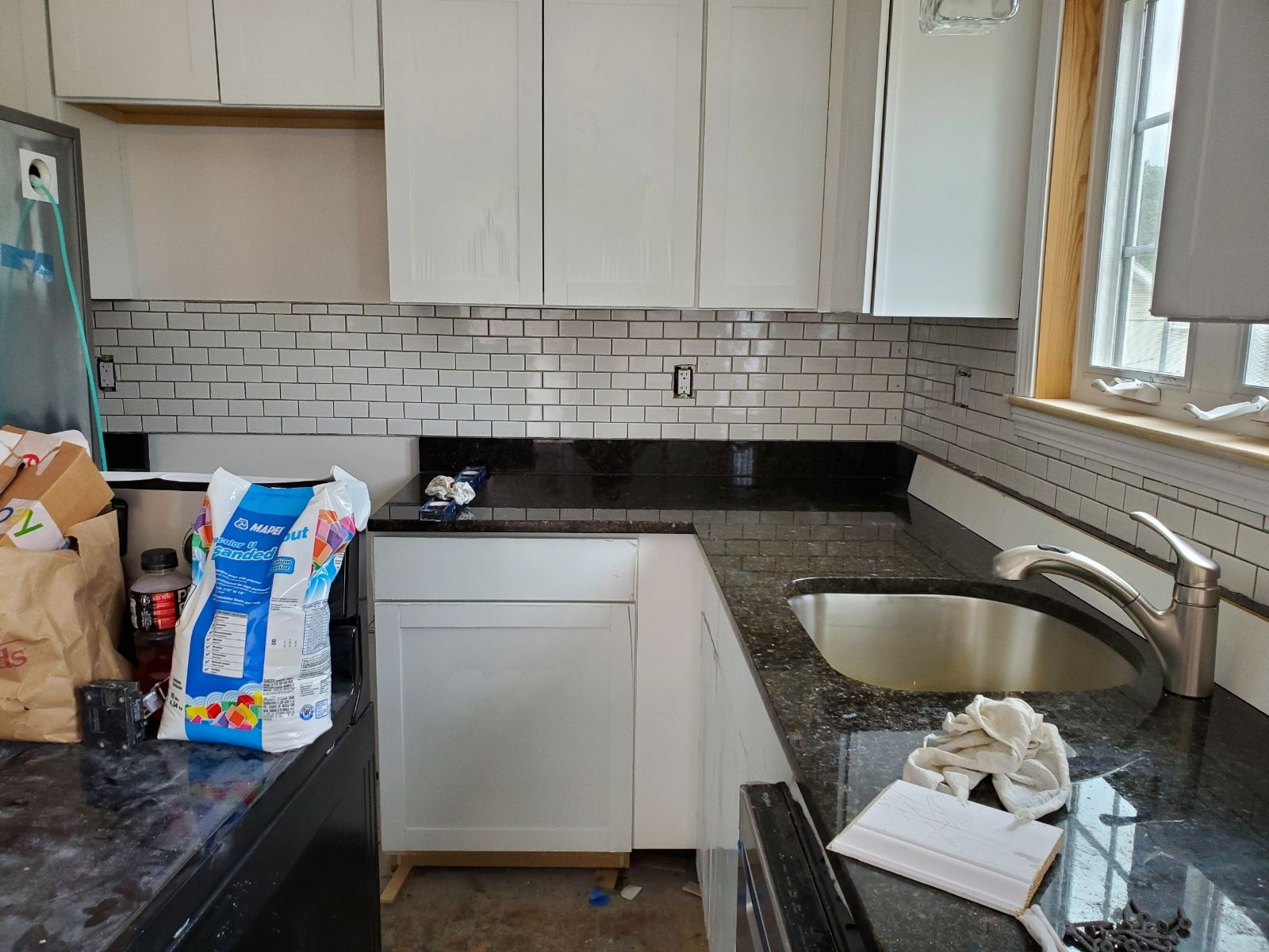 A Bag of Mapex tile adhesive sits on a kitchen counter  – Malden, MA – EG Remodeling LLC