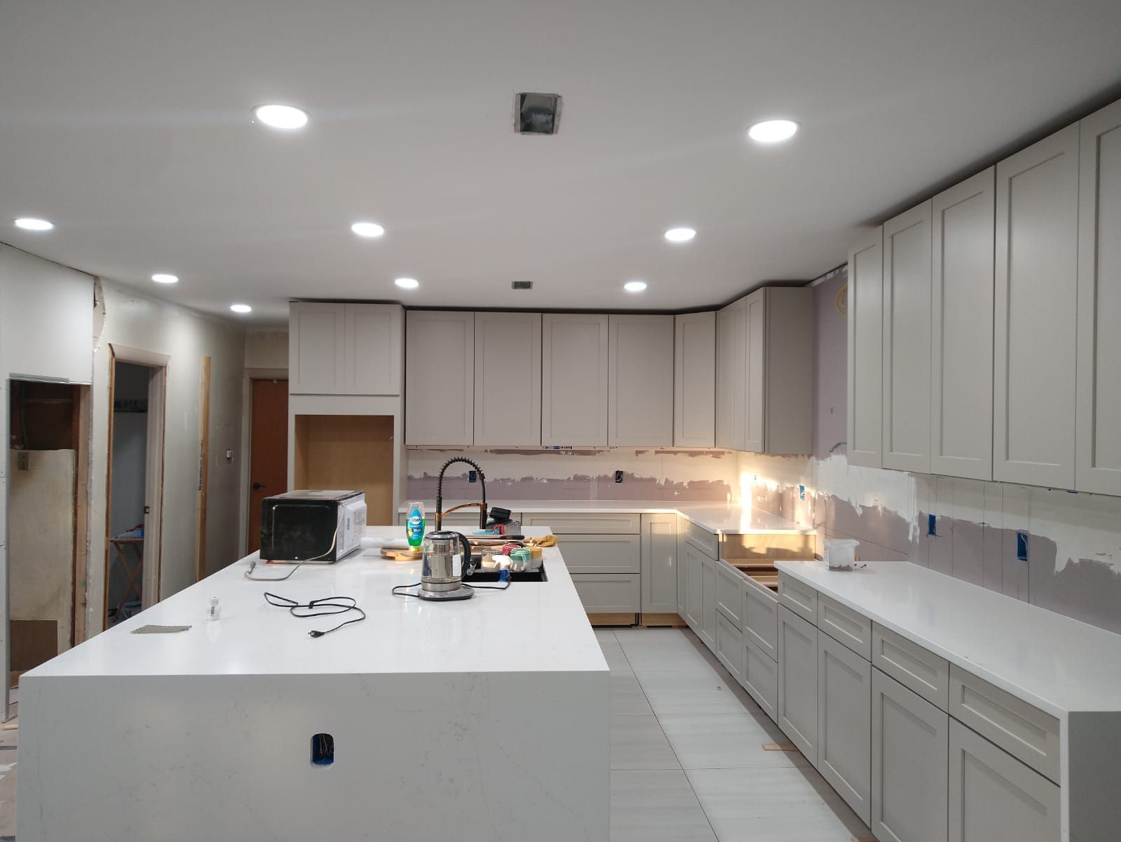 A kitchen under Construction with white cabinets and white countertops – Malden, MA – EG Remodeling LLC