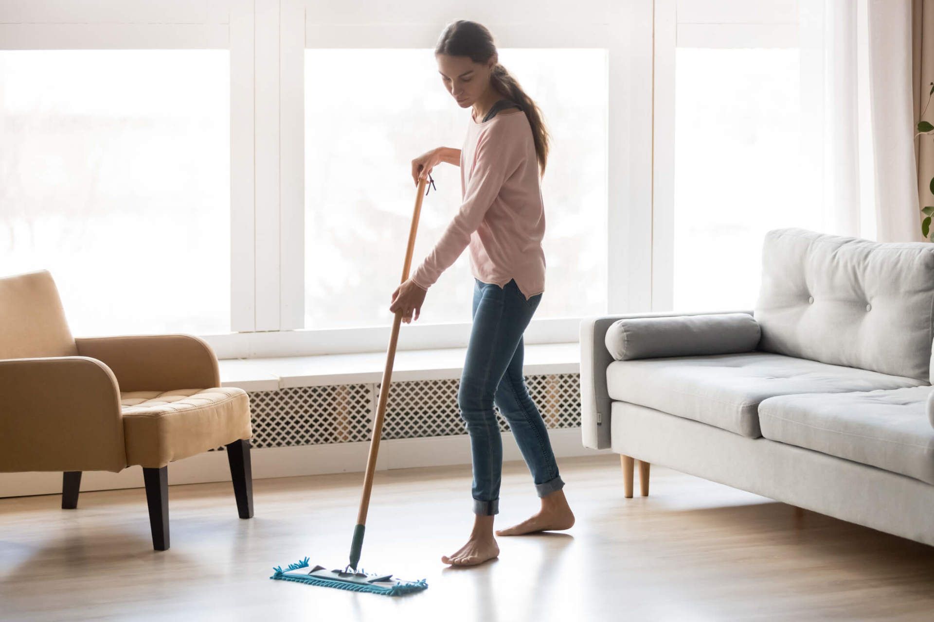 Woman Cleaning Wooden Floor Using Microfiber Wet Mop Pad — North Myrtle Beach, SC — Williams Carpet Center
