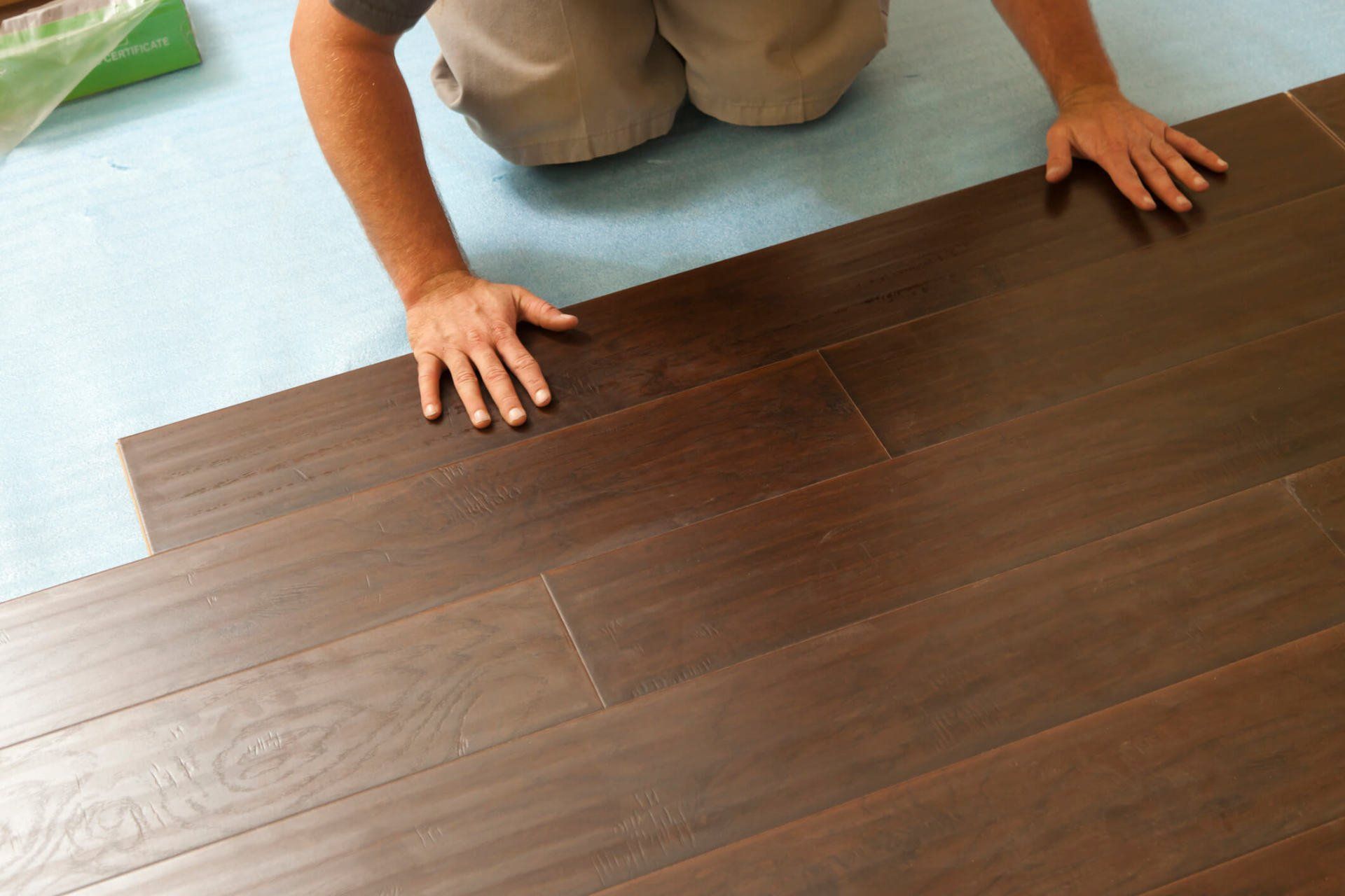 Man Installing New Laminate Wood Flooring — North Myrtle Beach, SC — Williams Carpet Center