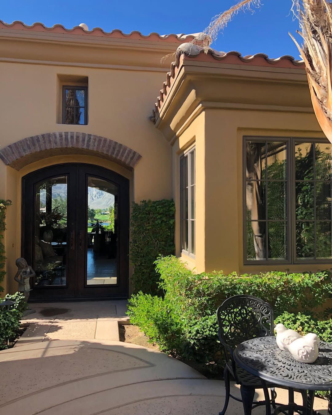 A house with a table and chairs in front of it