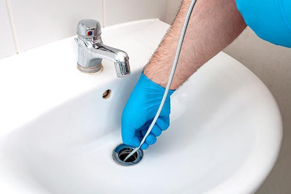 Plumber Repairing Sink — Santa Clarita, CA — Mike Wooley Plumbing