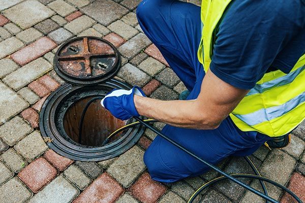 Worker Cleaning Blocked Sewer with Hydro Jetting — Santa Clarita, CA — Mike Wooley Plumbing