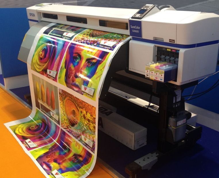 An epson printer is printing a large sheet of paper
