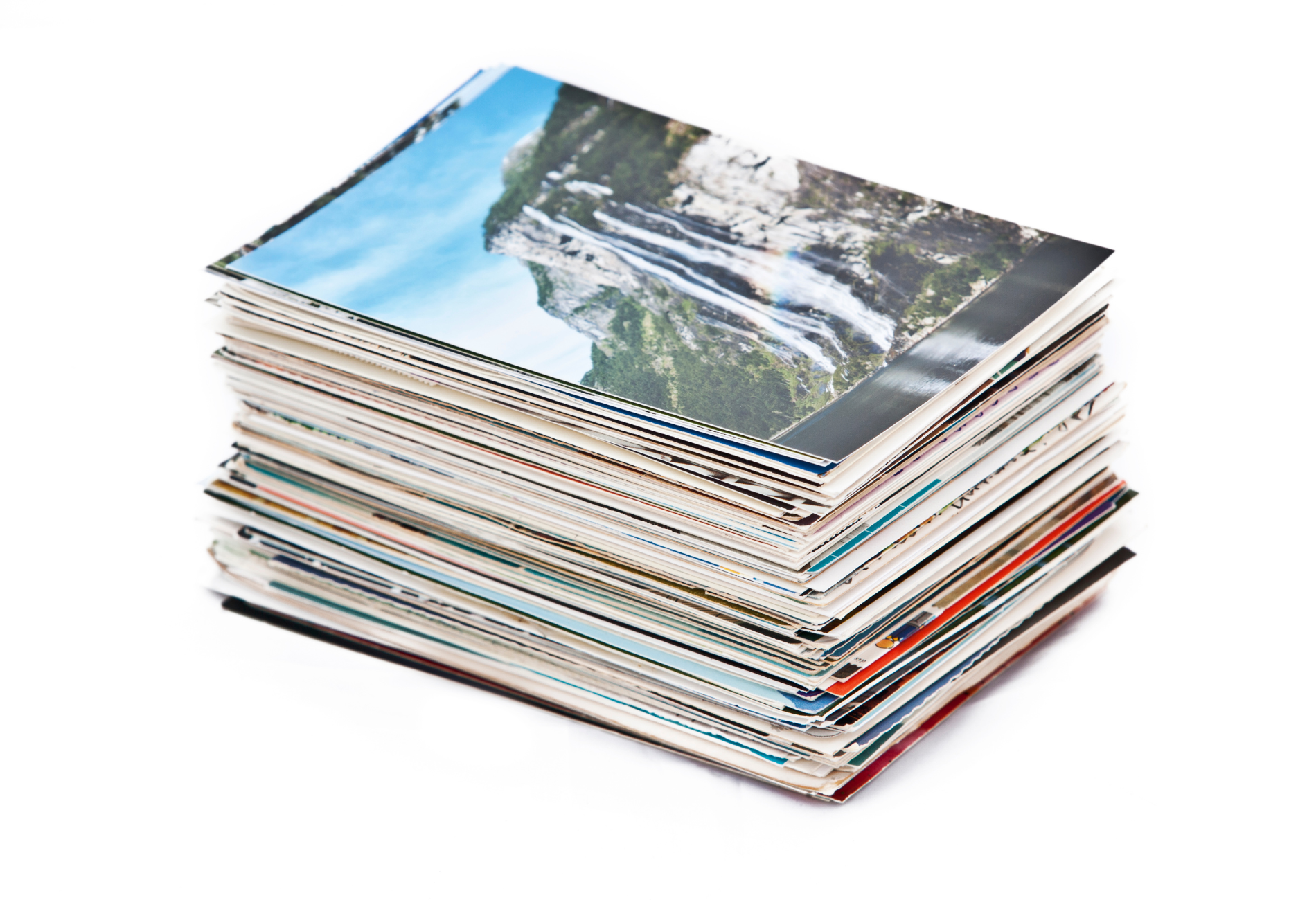 A stack of magazines with a picture of a waterfall on the top
