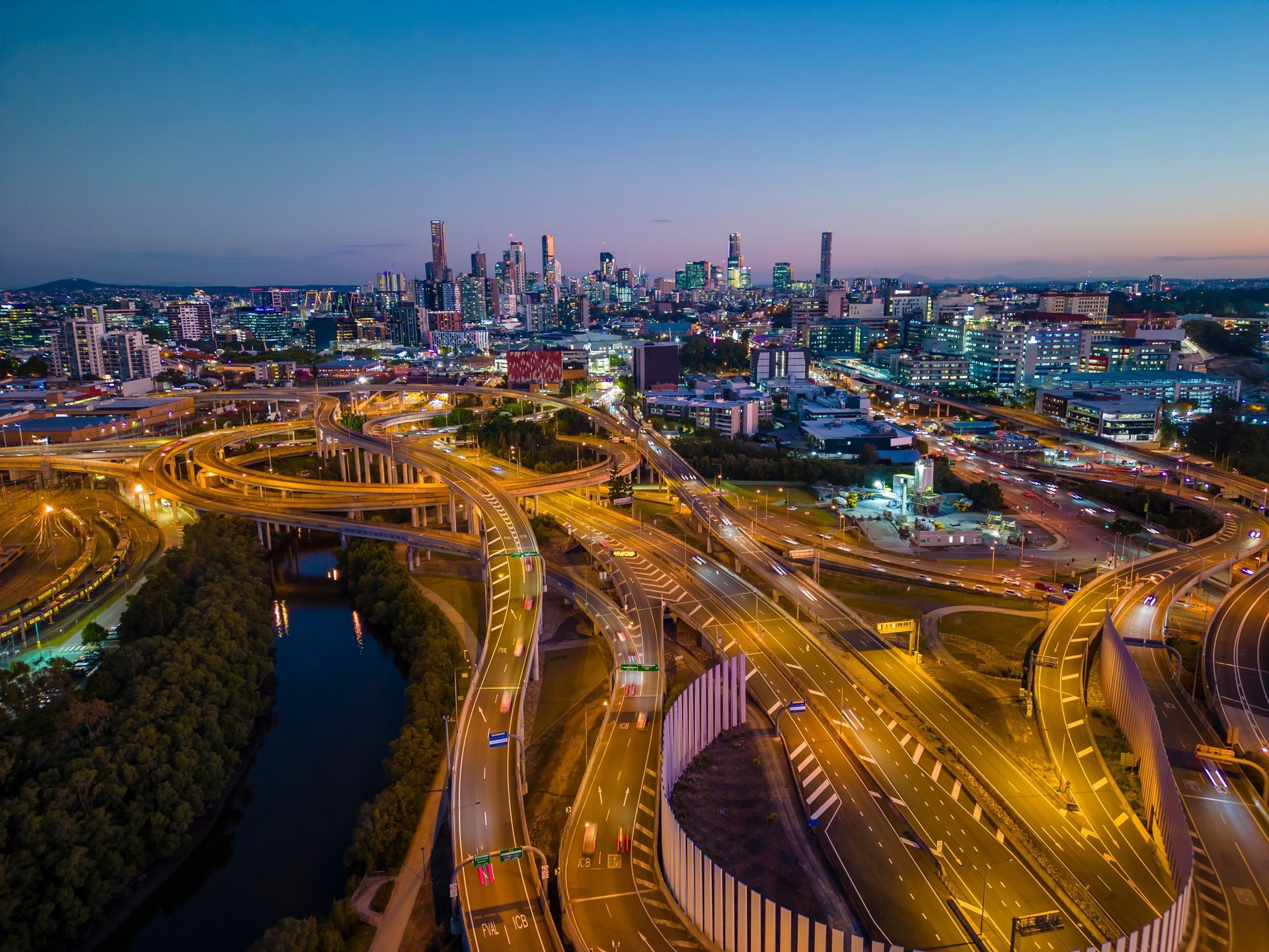 An aerial view of a city at night with a lot of roads and bridges.