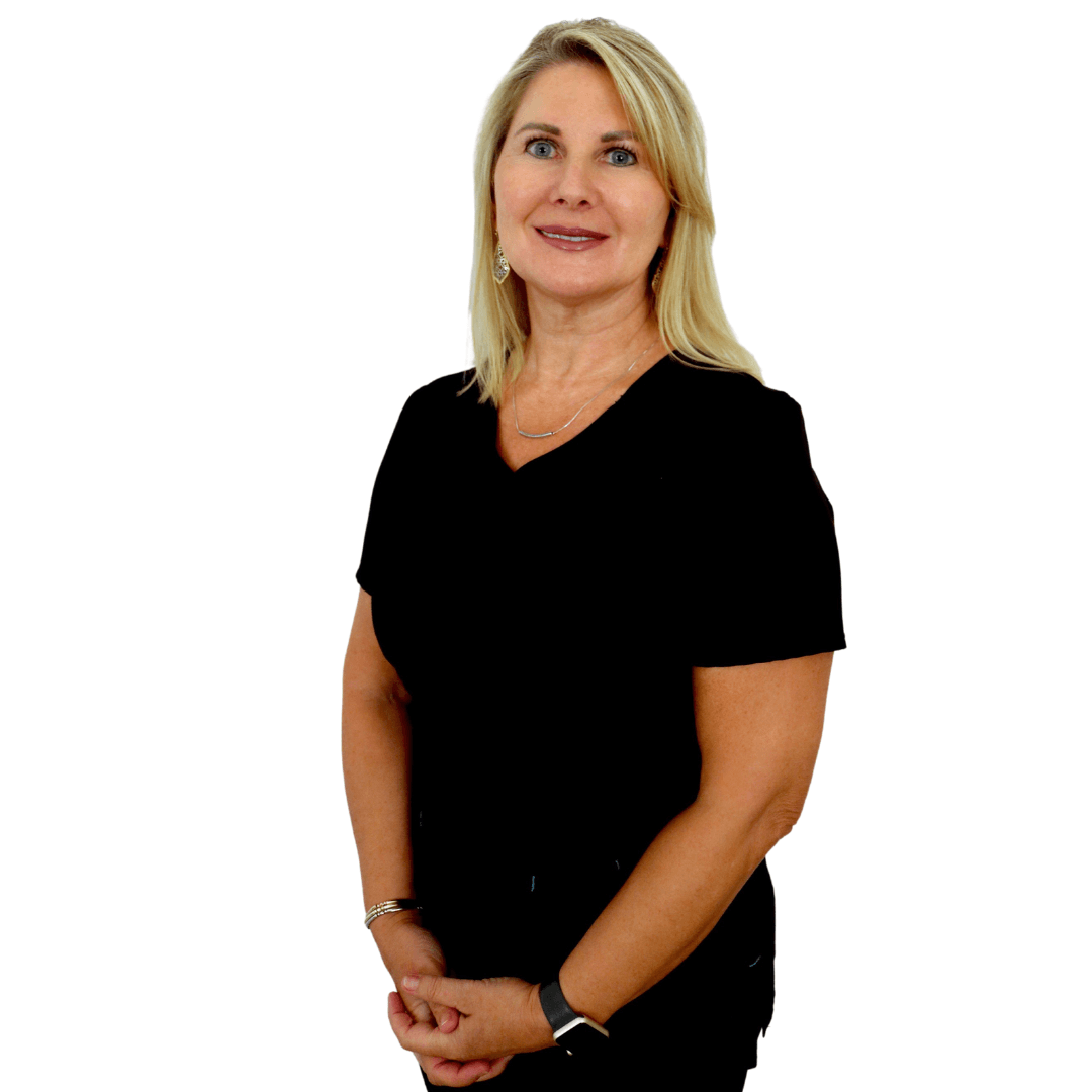 A blonde individual in a black short-sleeved top standing against a white background with hands clasped.