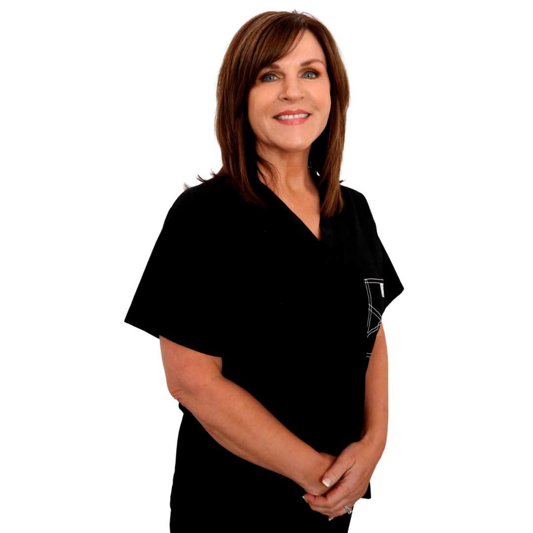 A person with shoulder-length brown hair and bangs wearing a black V-neck top, smiling against a plain white background.