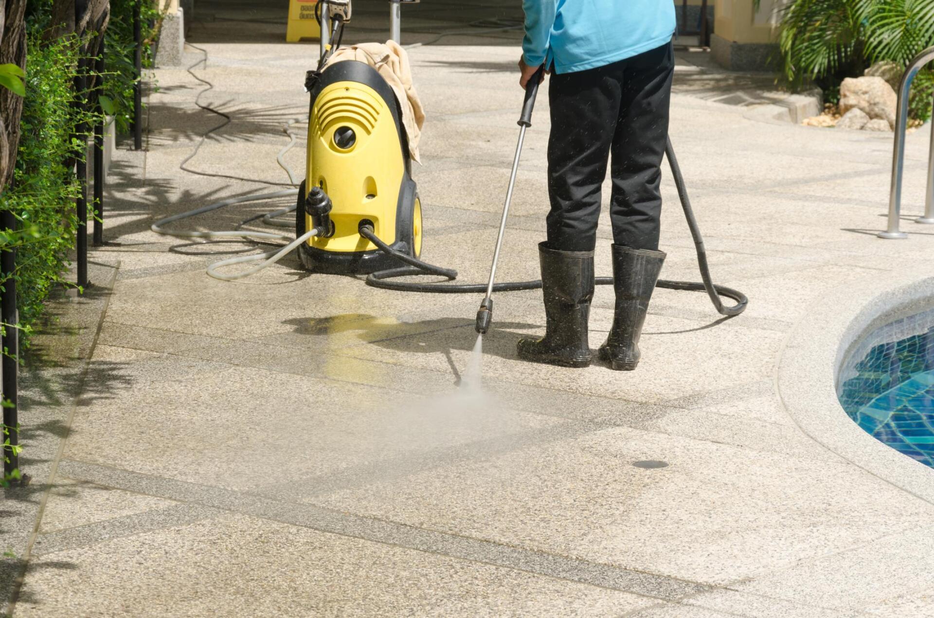 worker spraying the walkway