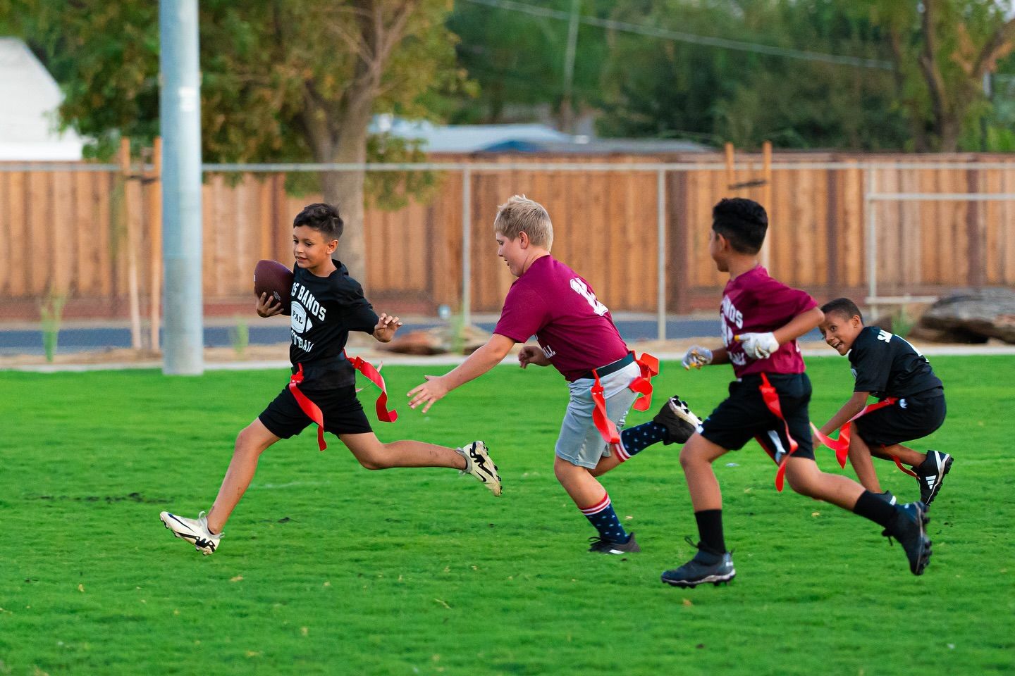 Basketball about to go through a hoop.