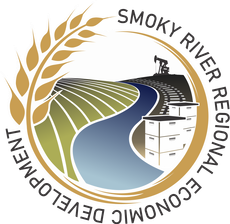 Circular logo featuring wheat, a winding river, an oil pumpjack, and beehives with the text 