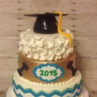 Three-tier graduation cake with black cap topper and “2015” plaque