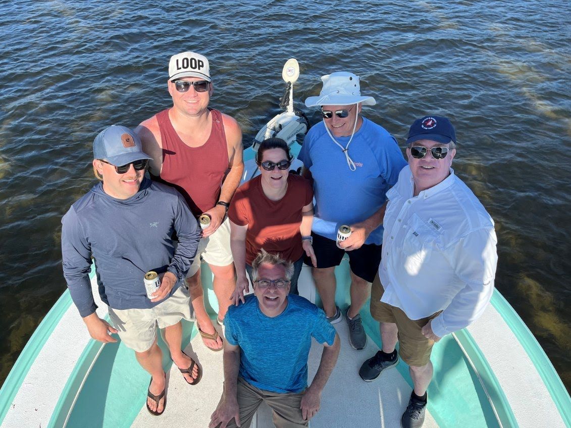 A group of people are posing for a picture on a boat.