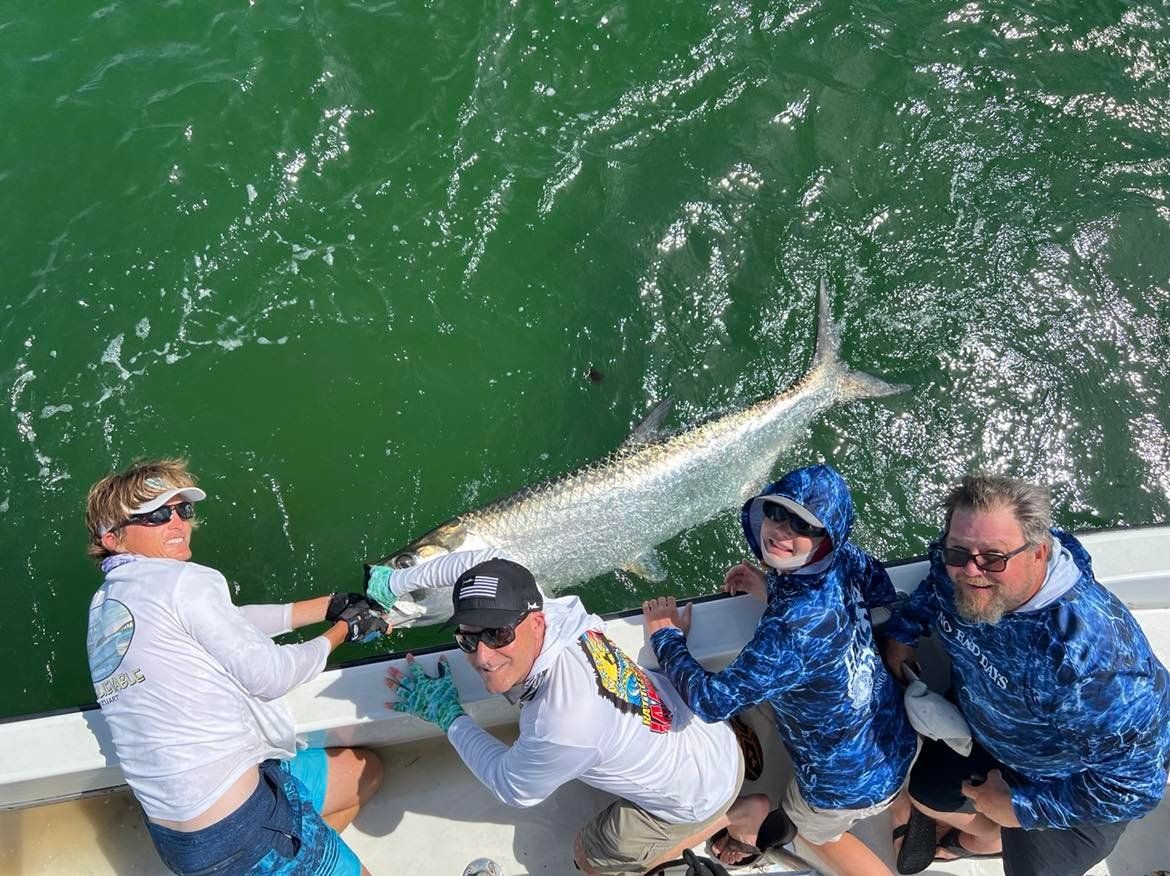 A group of people are fishing in the ocean on a boat.