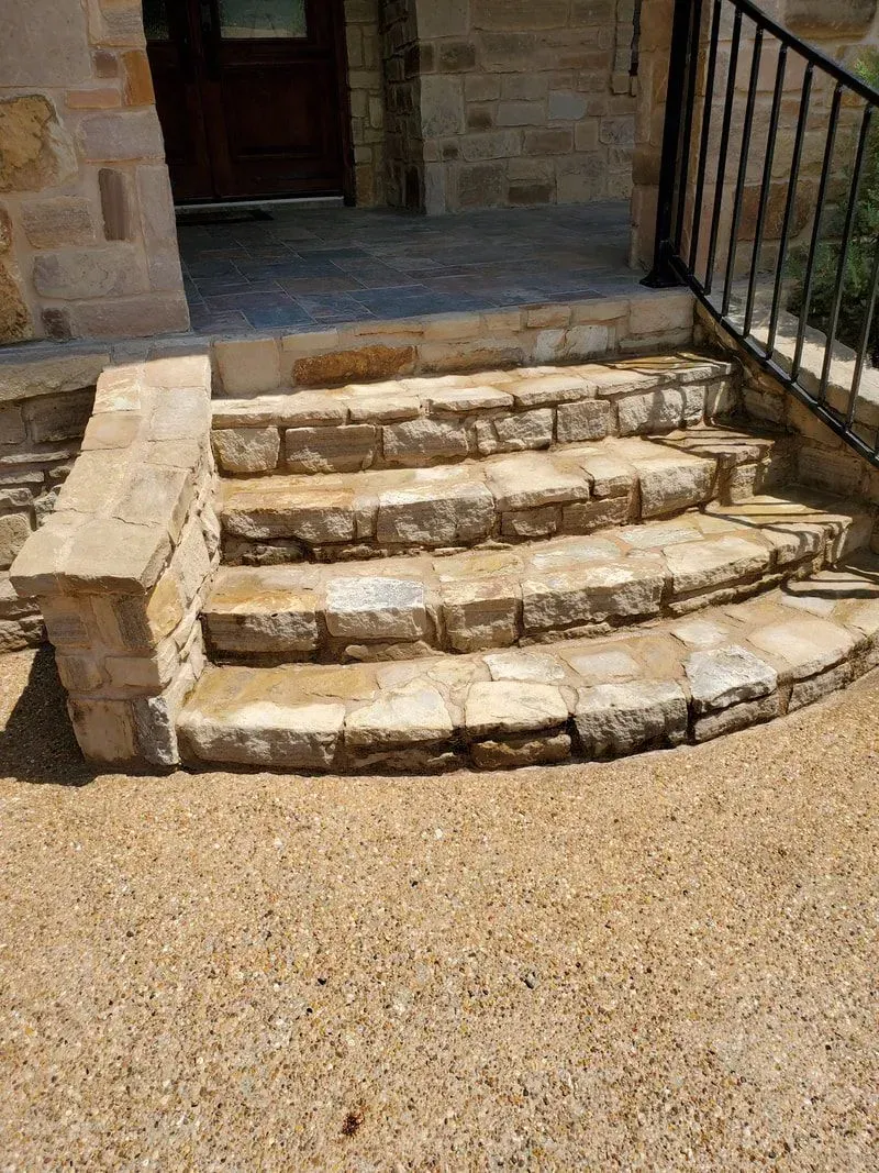 A set of stone steps leading up to a house.