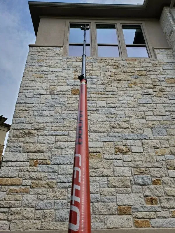 A large brick building with a red pole in front of it