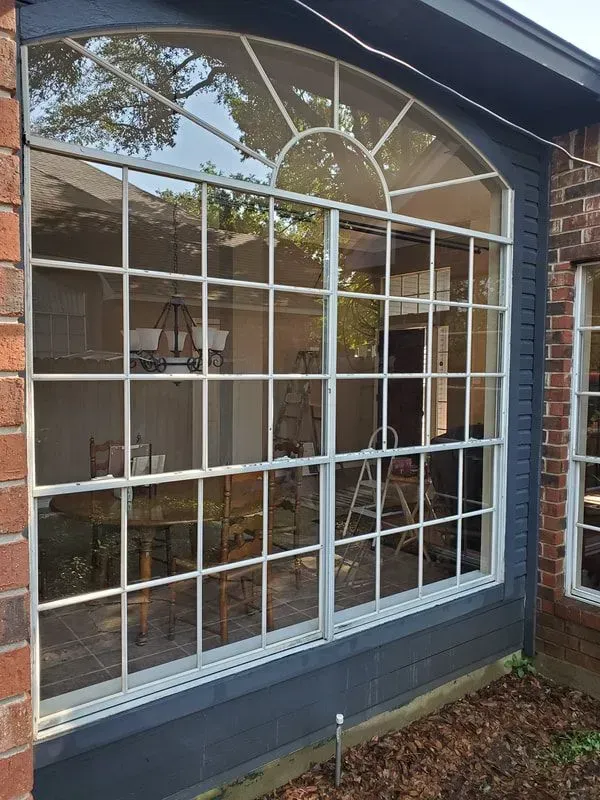 A large window on the side of a brick building.