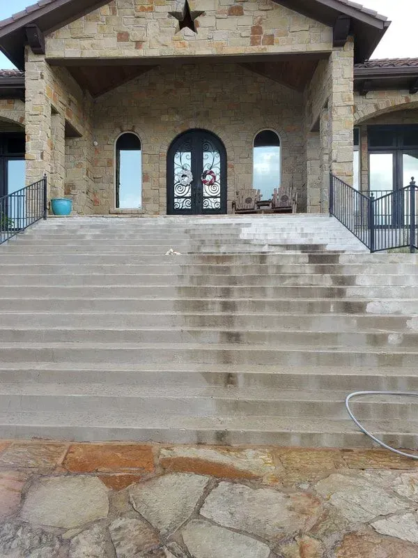 A house with a star on the front of it and stairs leading up to it.