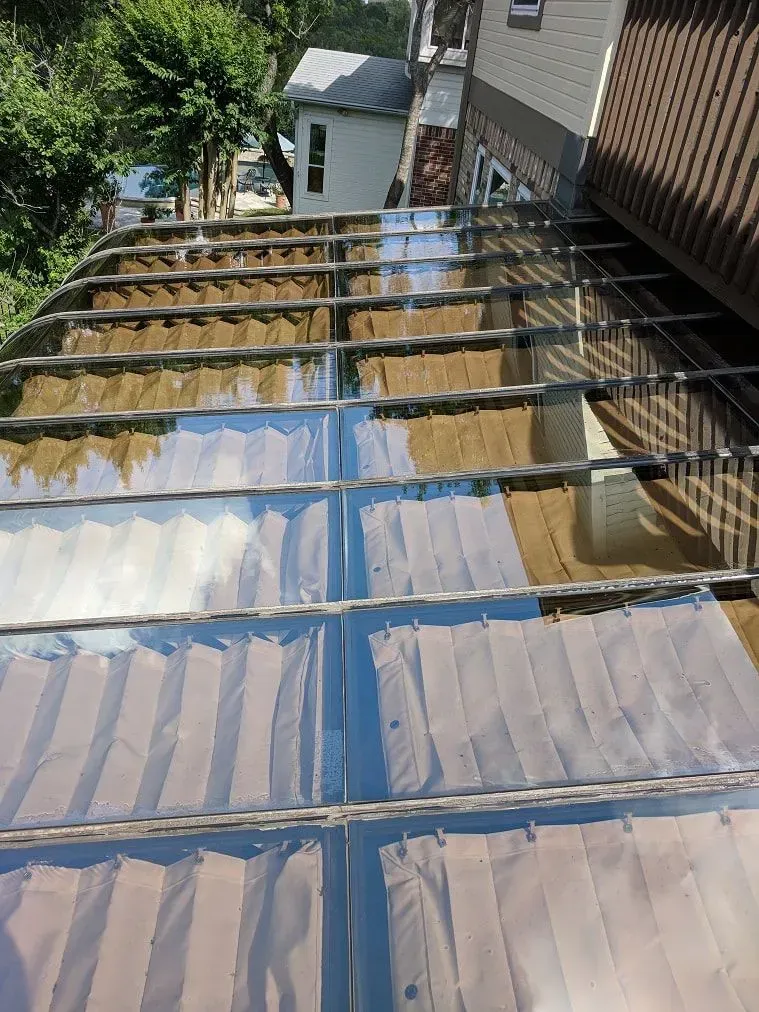 The roof of a building with a clear plastic roof.