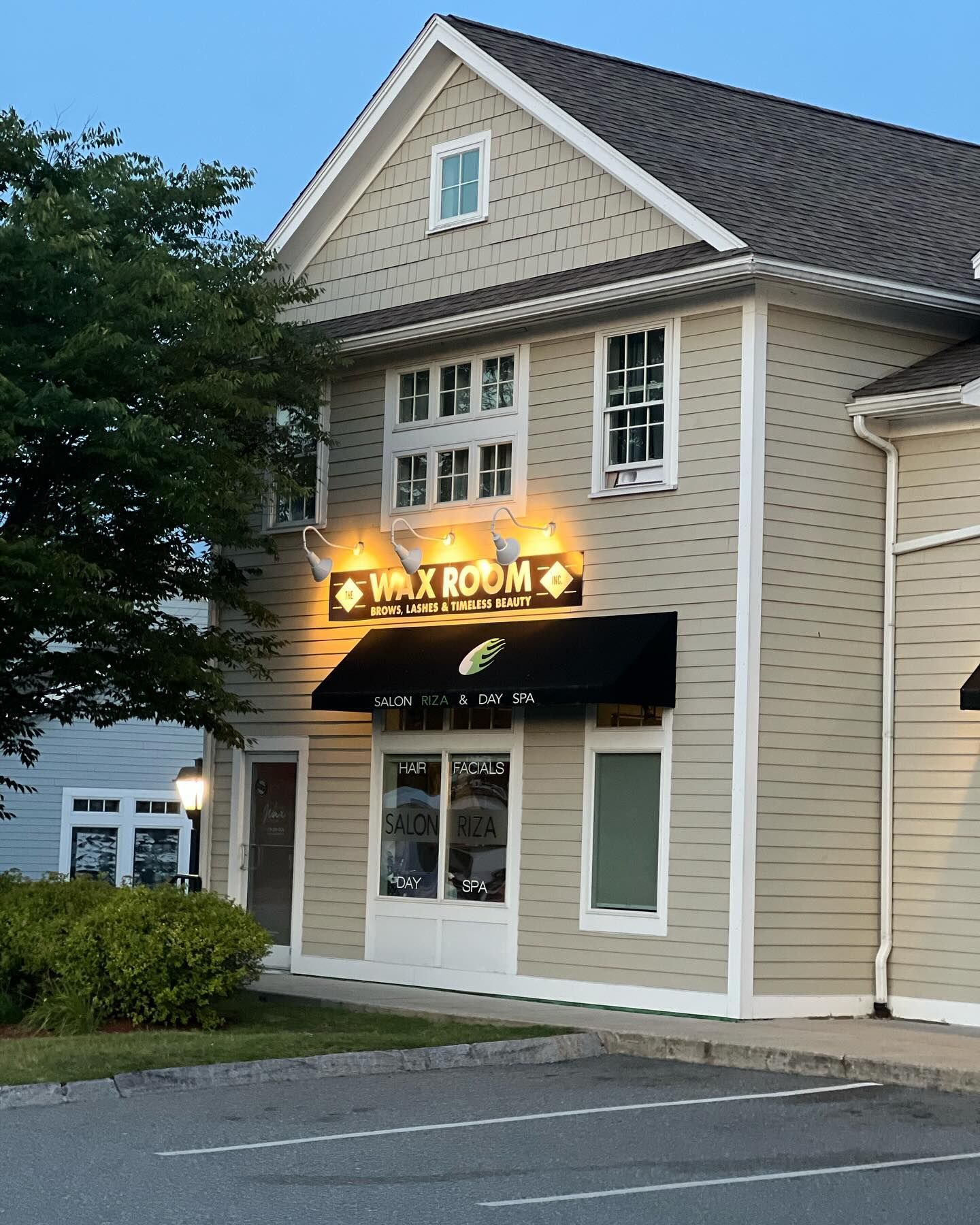 A building with a sign that says wax room on it