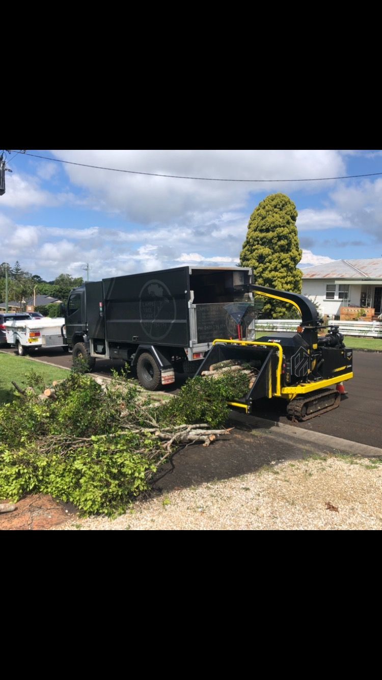 chipper machine working with black truck — Arborist Servicing in Alstonville, NSW