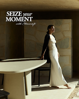 Woman in white outfit leans on table