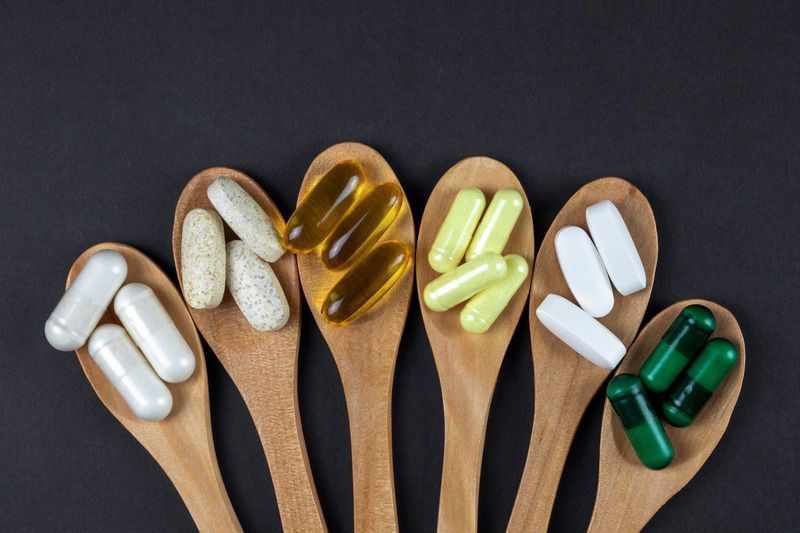 A pharmacist is looking at a tablet in a pharmacy.