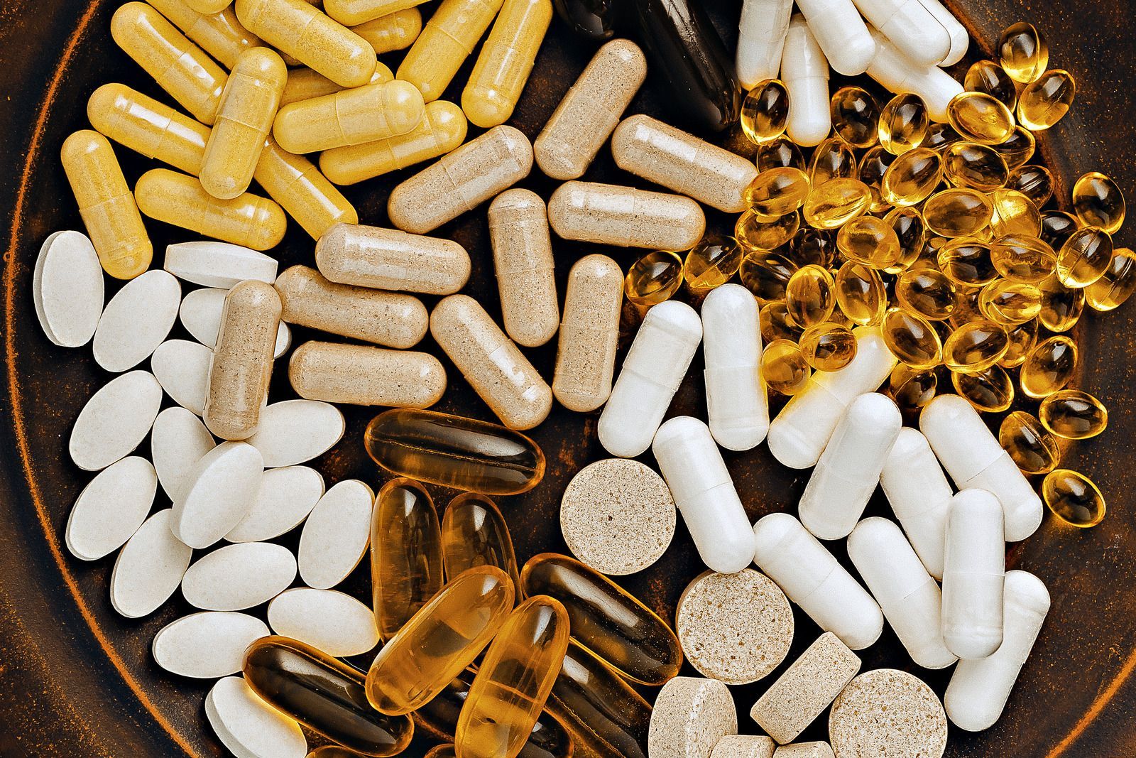 A plate of different types of pills and capsules