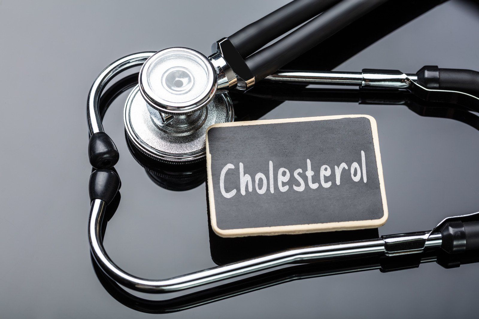 Stethoscope around a chalkboard with the word 