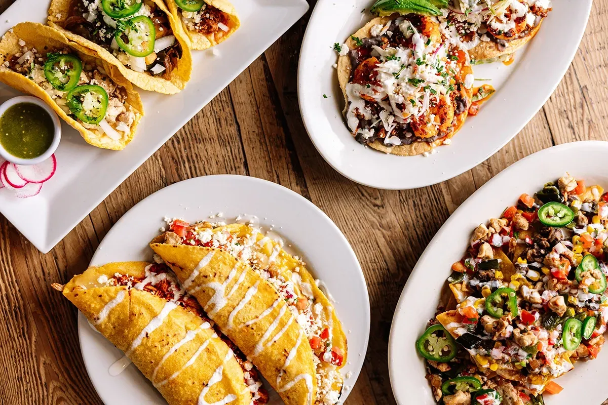 There are many different types of food on the plates on the table.