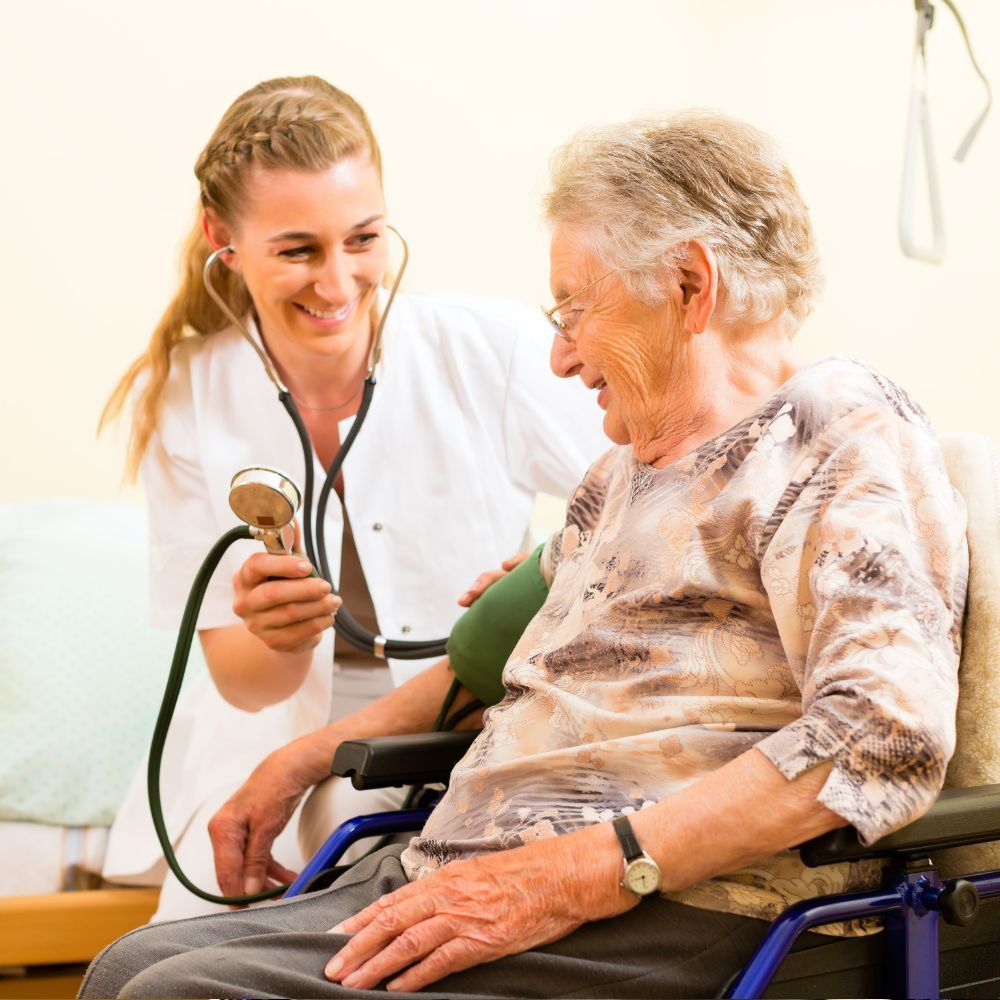 A nurse helps her elderly patient
