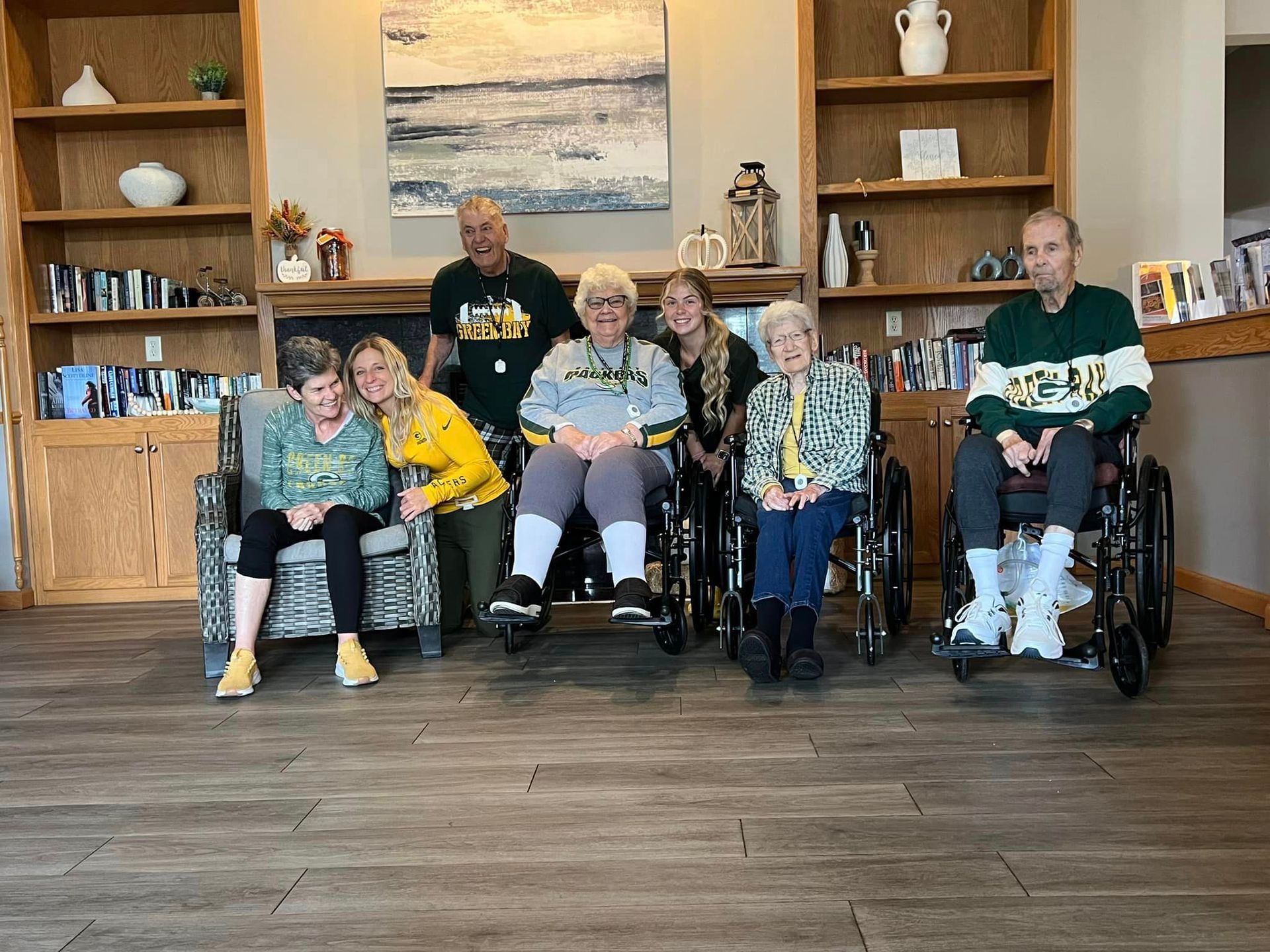 A group of people are posing for a picture in a living room.