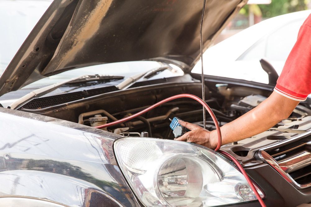 A Man Is Working on The Air Conditioning System of A Car with The Hood Open — A & K Auto Electrical & Air Conditioning in Tamworth, NSW