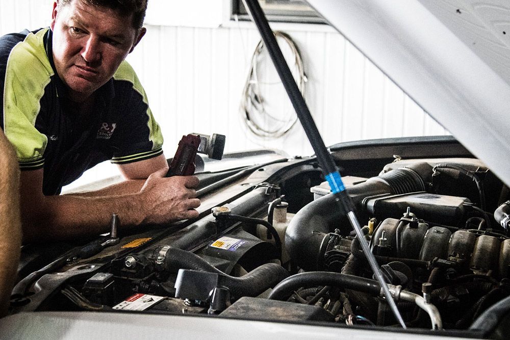 Auto electrician inspecting the engine bay for faults — Auto Electrical & Air Conditioning in Tamworth, NSW