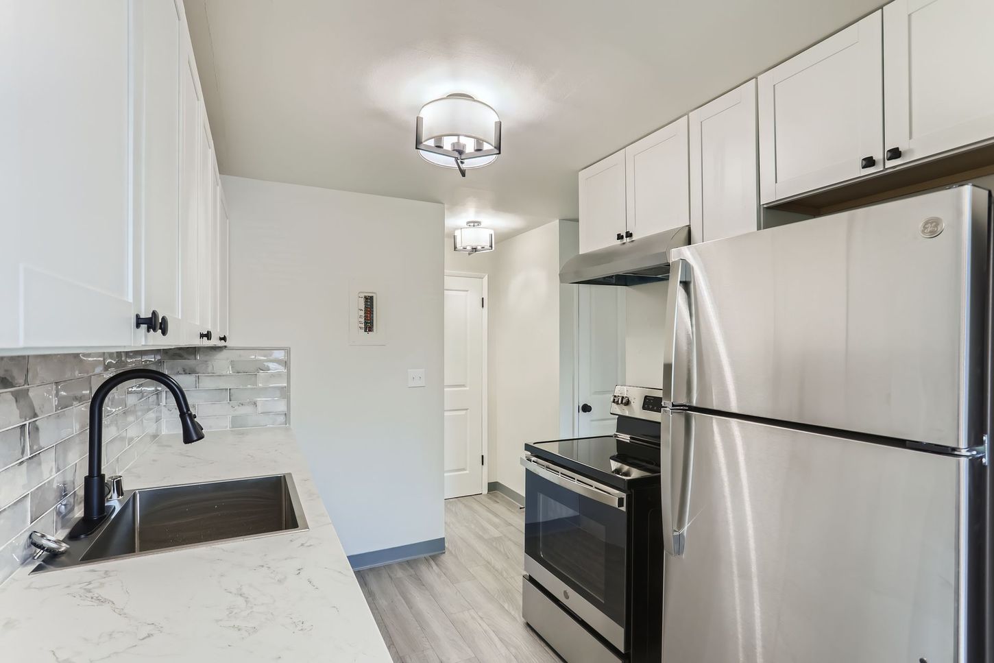 Photo showing the kitchen, with a hallway in the backgorund