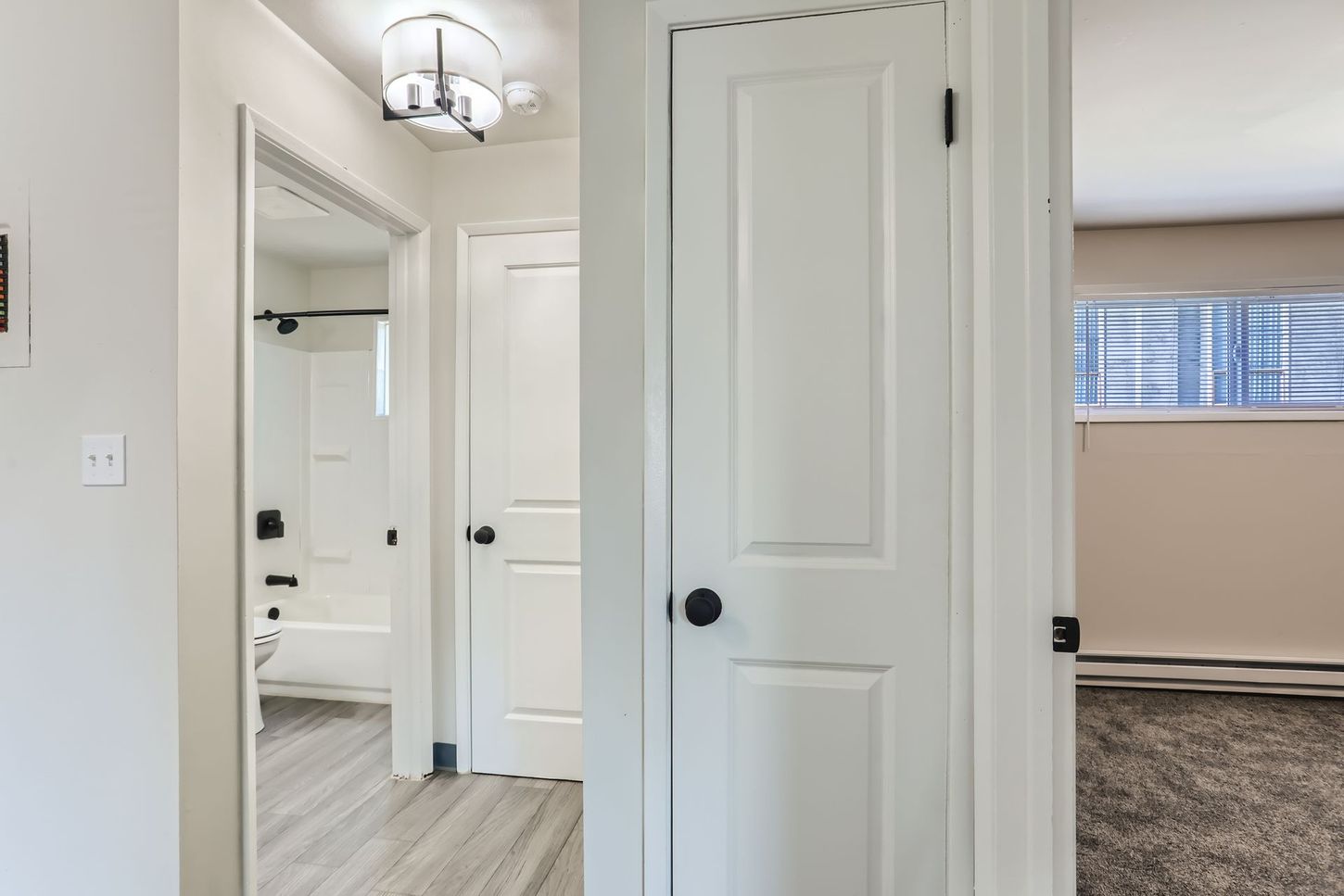 Photo showing a hallway leading to a bathroom