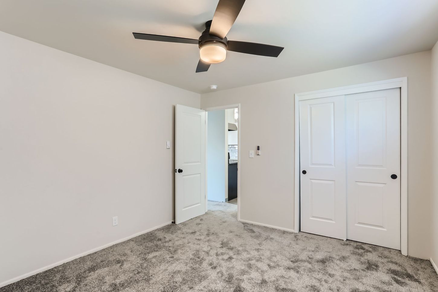 Photo showing a bedroom with a dual door closet and ceiling fan