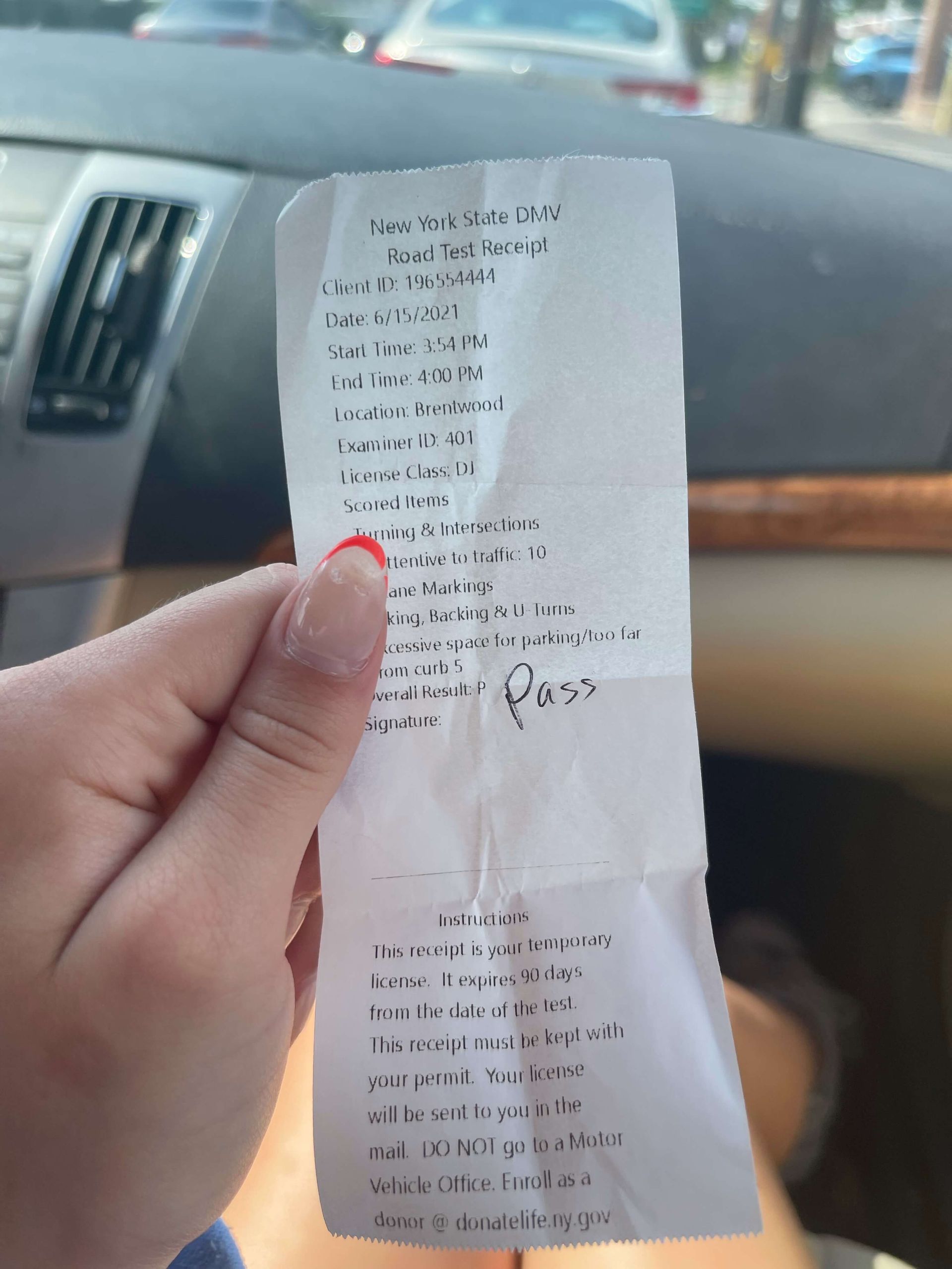 Hand holding parking receipt, marked 