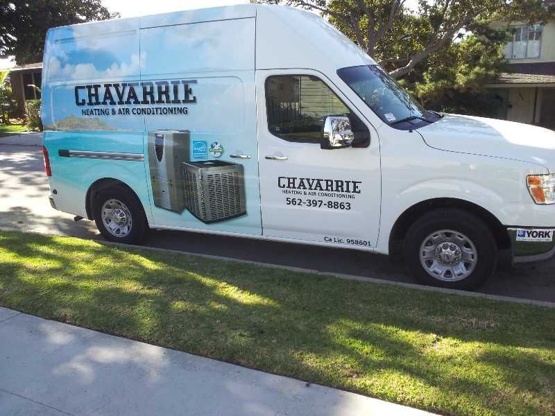 White Chavarrie Heating and Air Conditioning van parked on grass.