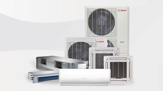 Assorted air conditioning units, including wall-mounted, ceiling cassette, and outdoor units, against a white background.