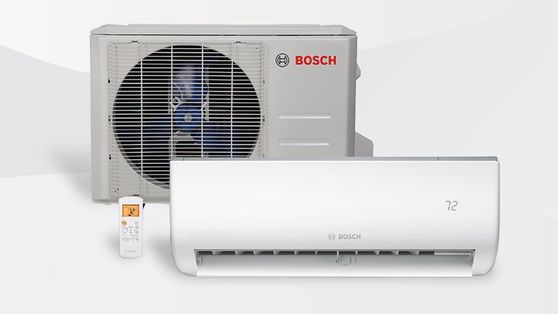 Bosch air conditioning system: outdoor unit and indoor wall unit, white, with a remote control.