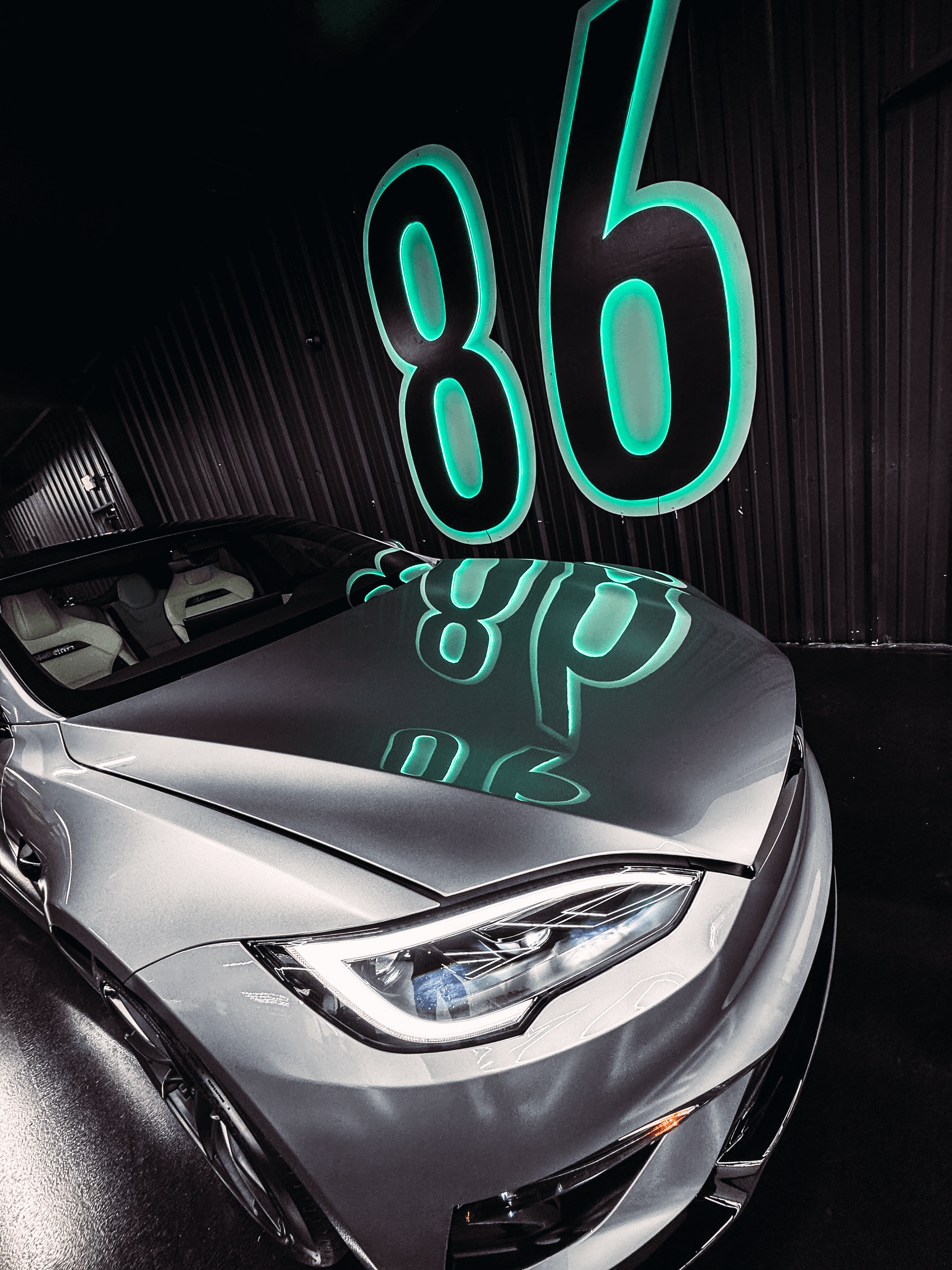 A yellow car is parked in a garage doorway.